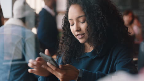 beautiful teenage girl using smartphone drinking coffee in cafe texting sharing messages on social media enjoying mobile technology