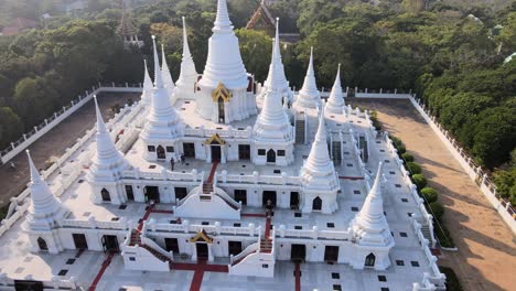 4k aerial middle shot of the wat asokaram temple at sunset in bangkok, thailand