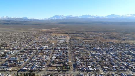 aerial view of malargüe city with the andes mountains in the distance.