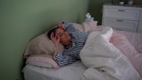 cheerful mature woman waking up and putting on eyeglasses