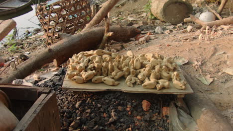 handcrafted pottery animals on a wooden board, ready to be fired in the oven