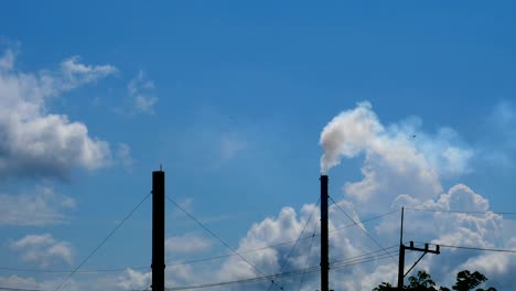 white smoke from the chimney of the factory