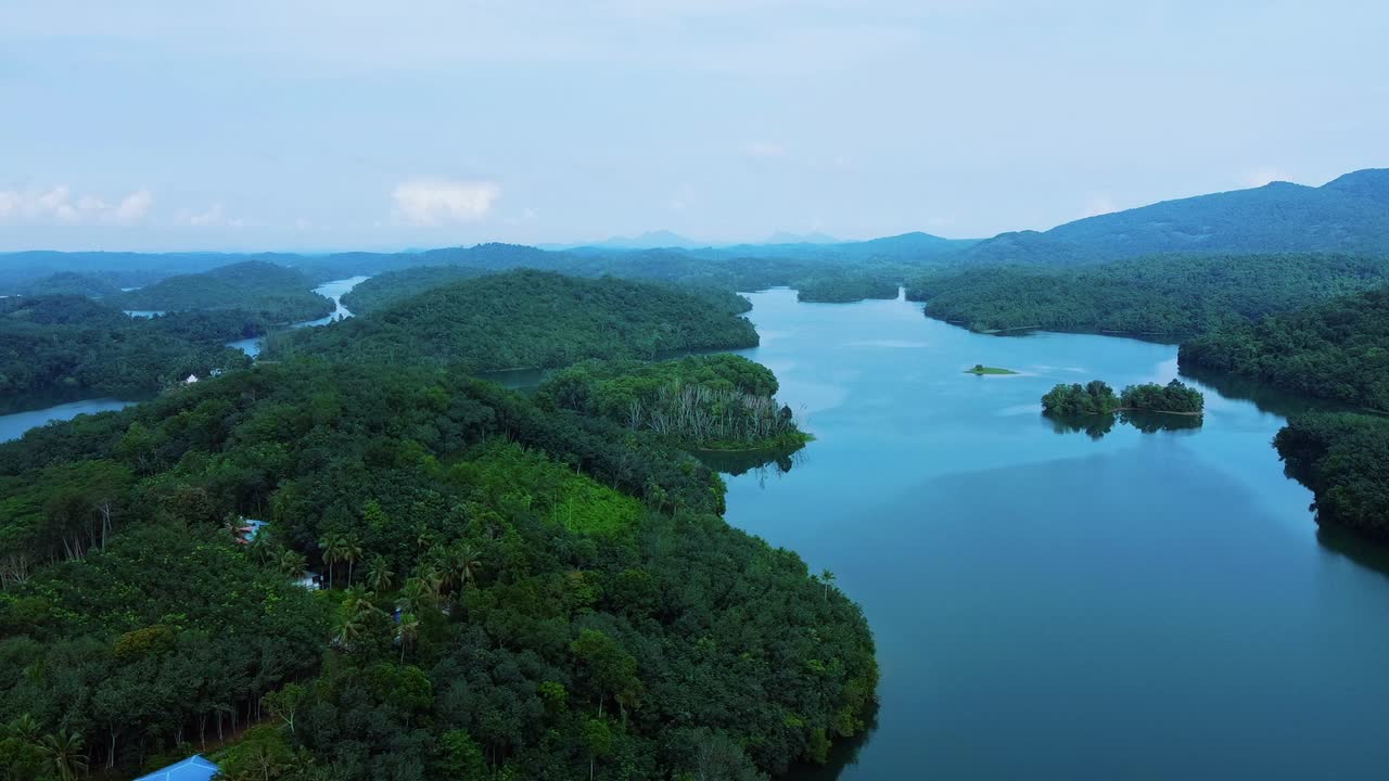 Aerial View of a Serene Lake Surrounded by Lush Green Mountains
