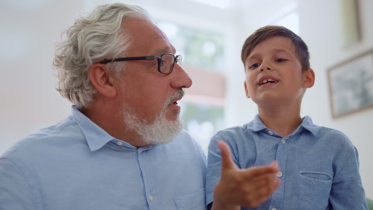 niño alegre sentado en los regazos de los abuelos