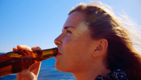Woman-having-beer-in-the-beach-4k