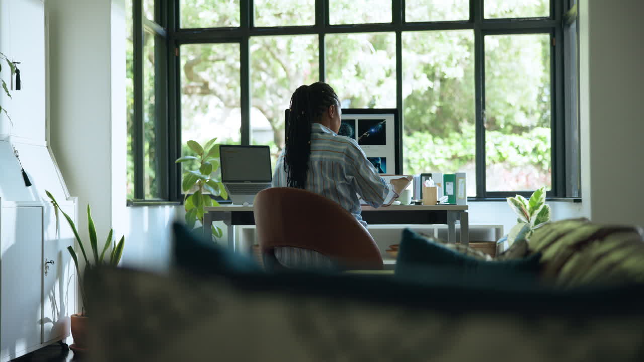 Woman Working on Computer in Bright Home Office by Window