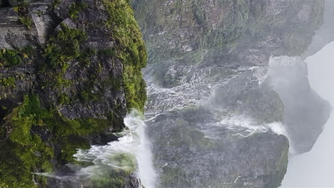 vertical - disappearing waterfall at milford sound in new zealand