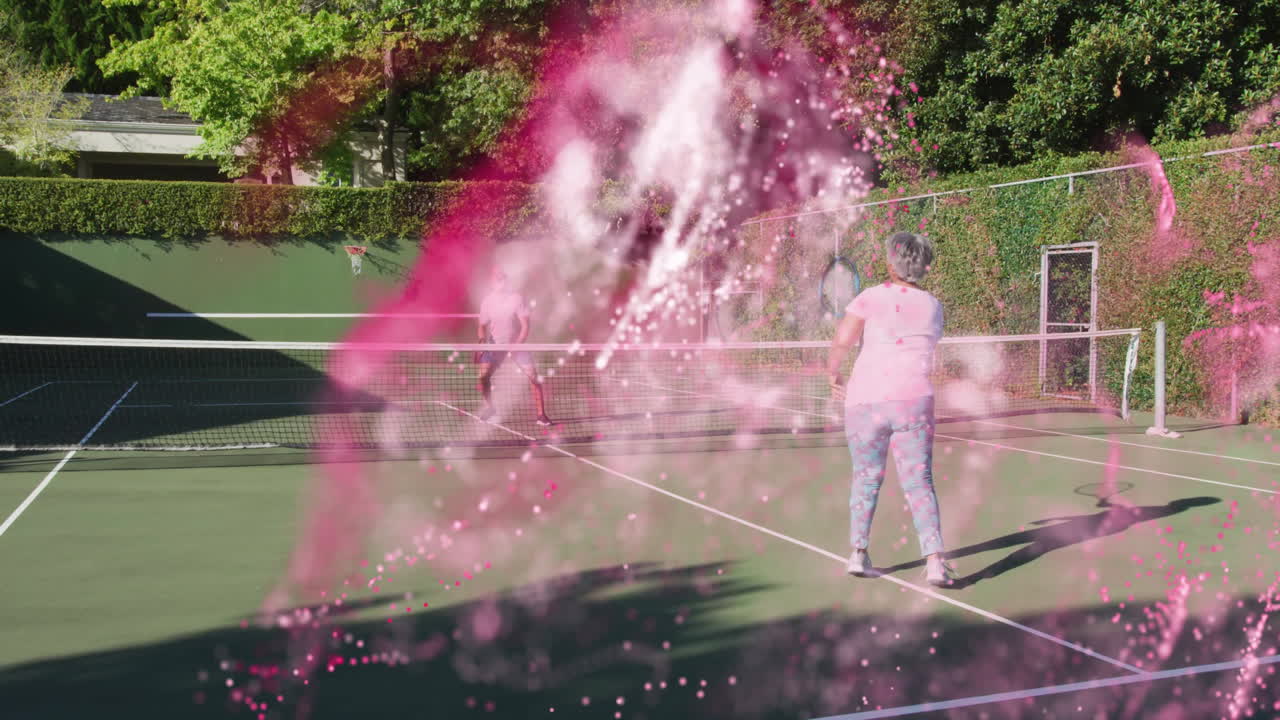 Male and female player playing tennis on court, with pink smoke swirl drifting for health marketing