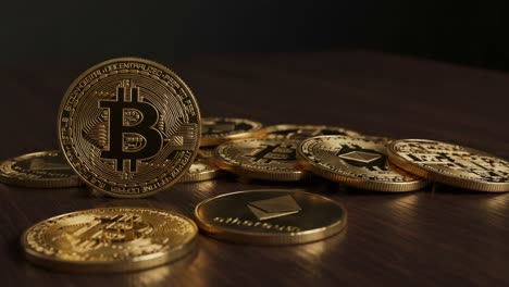a collection of cryptocurrency coins highlighting bitcoin and ethereum, showcasing the growing digital currency landscape with a focus on their unique designs and features.