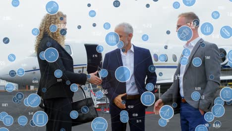 animation of network of digital icons over businesspeople shaking hands at the airport