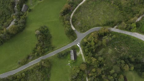 Top-view-of-Waidischer-street-near-Freibach-reservoir-in-Austria-with-parked-van,-Aerial-lowering-shot