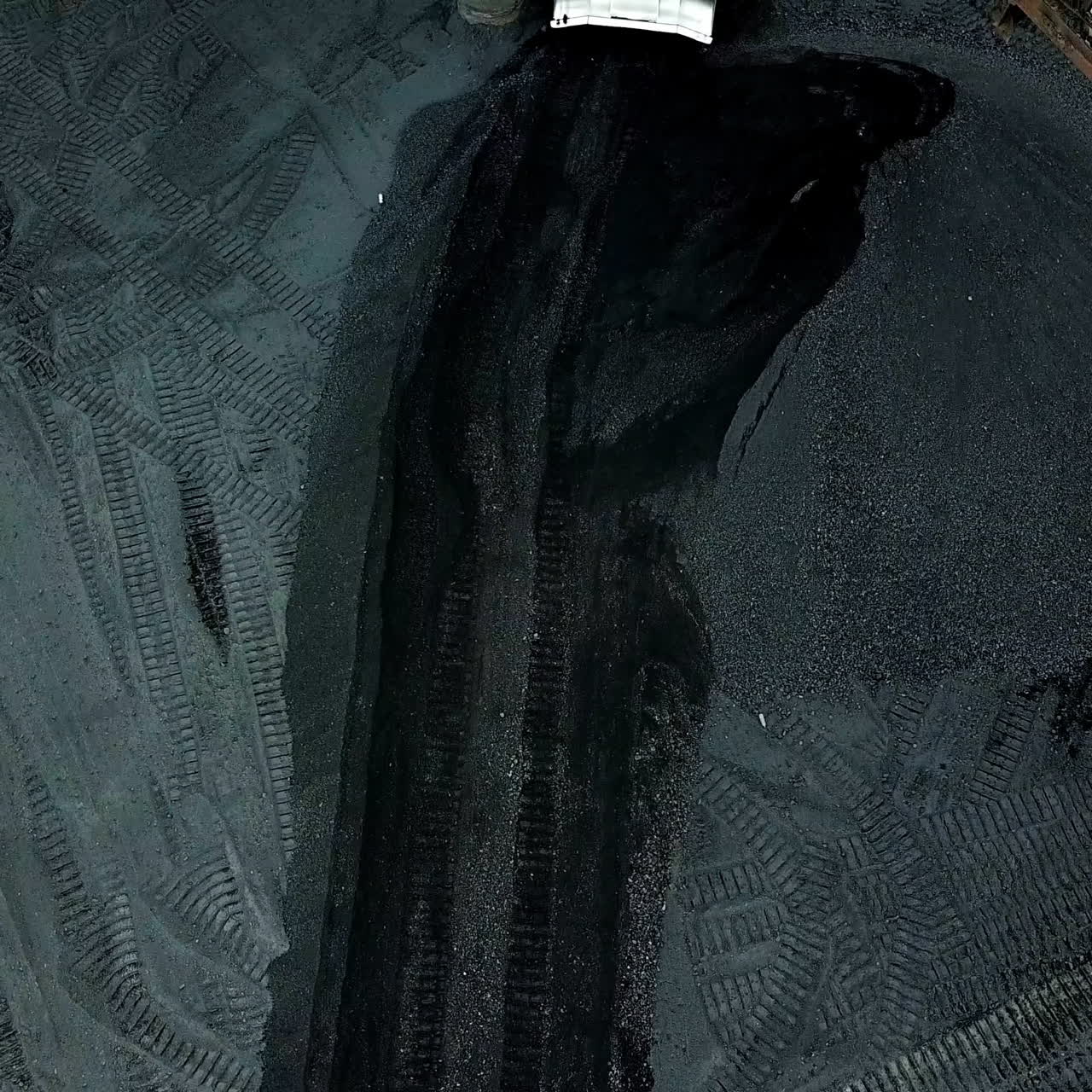 Moving tractor coal around plant for processing. Coal Production. Aerial view.