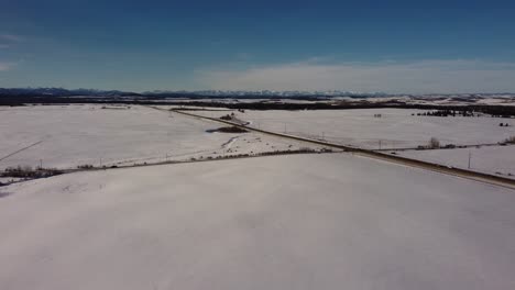 Aerial-view-of-the-winter-highway-in-Alberta,-Canada