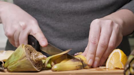 Woman-cut-artichoke.-Cooking-process.-Closeup