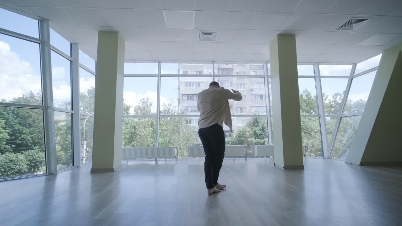 Man Breakdancing in Modern Studio