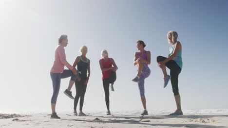 senior women stretching in the beach