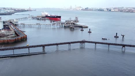 shipping tanker loading at tranmere shell oil industrial harbour terminal descending shot