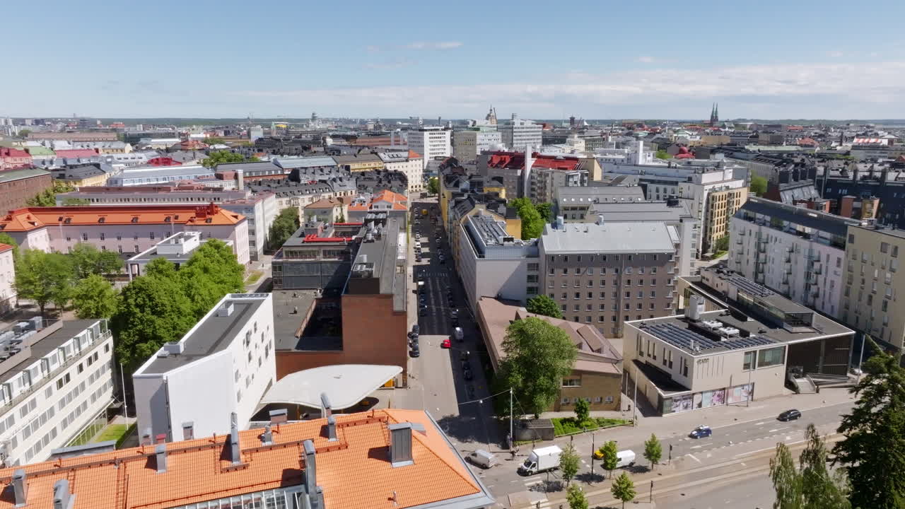 Aerial view descending in front of streets and buildings in Toolo, Helsinki