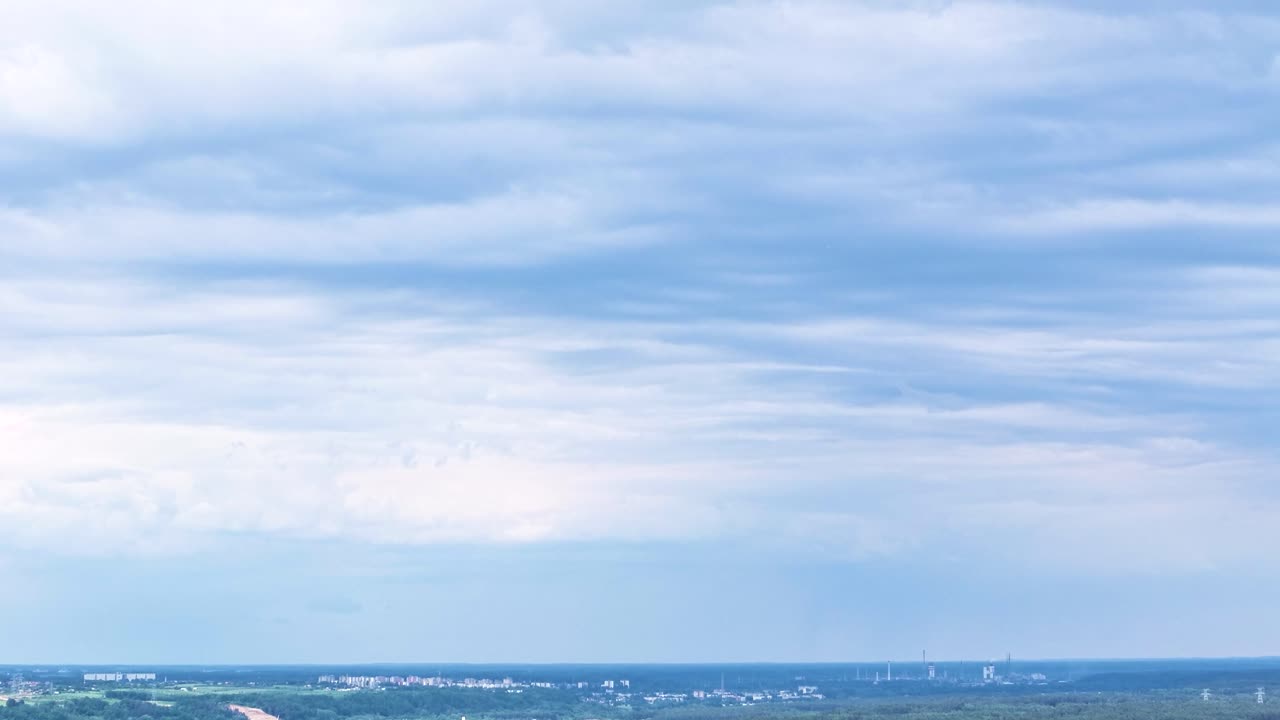 Dark blue clouds flowing above Lithuania, aerial time lapse view