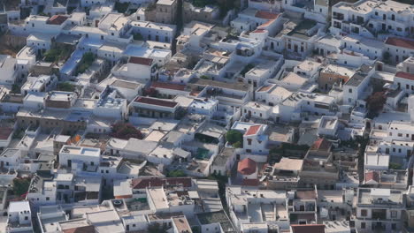 tight circling aerial shot over lindos town houses