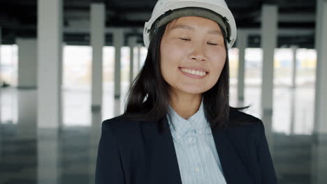 Smiling Asian Woman Engineer in a Construction Site
