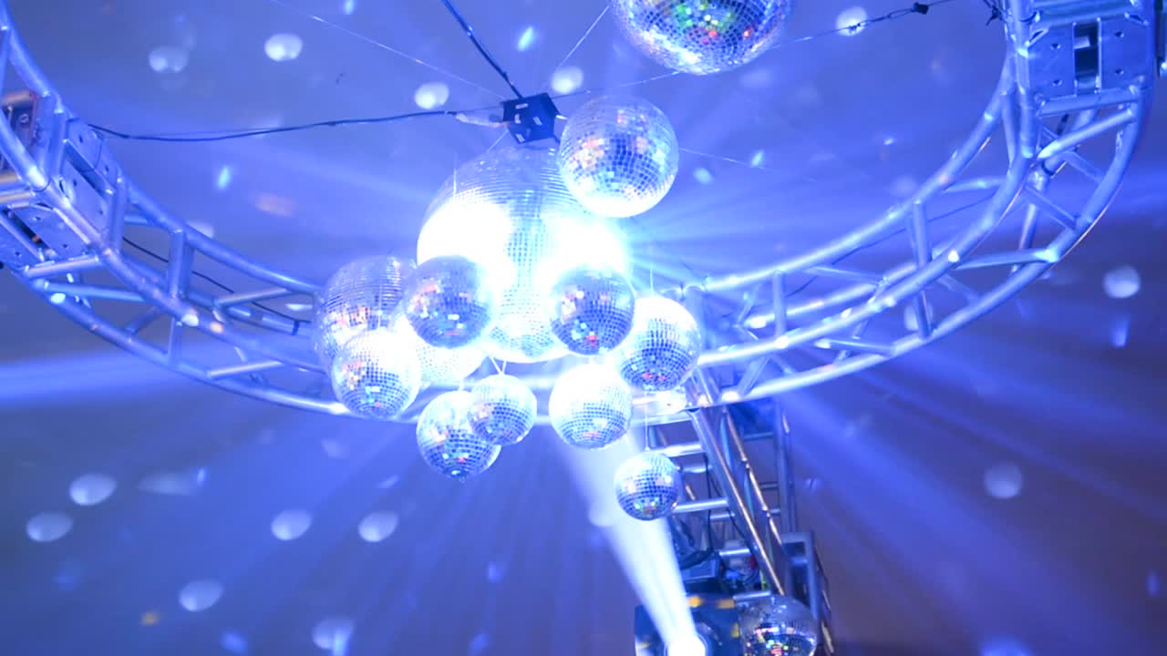 천장까지 올라가는 기울기 움직임, 파티에서 색색의 조명을 반사하는 많은 미러 글로브 캡처