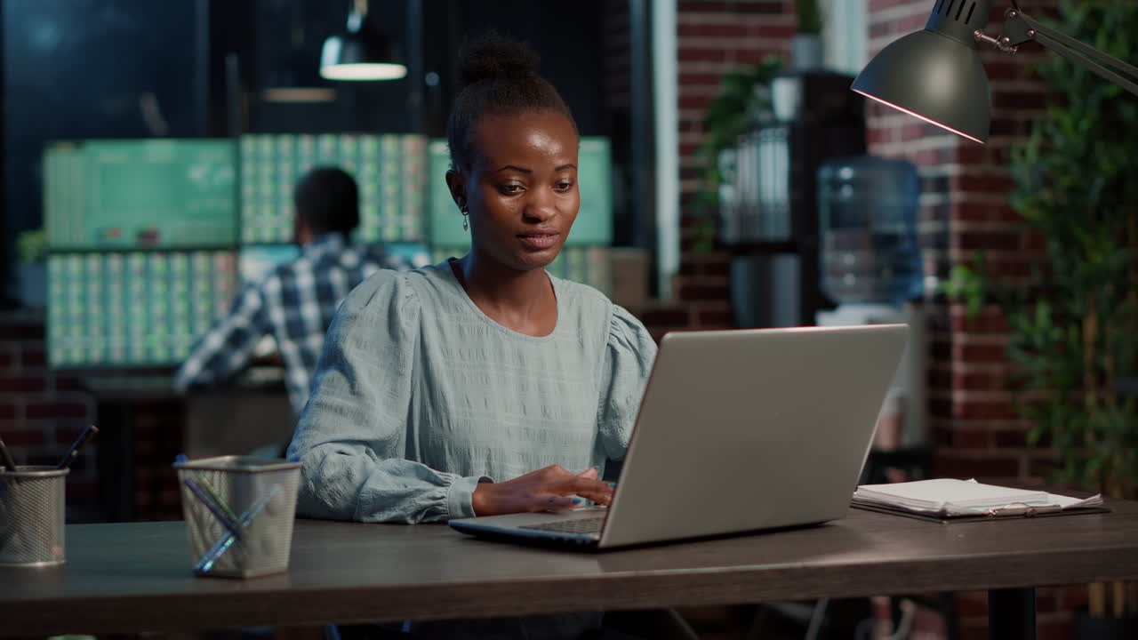 Financial analyst using laptop to work on forex sales statistics