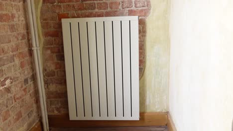 modern wall mounted radiator in a brick room