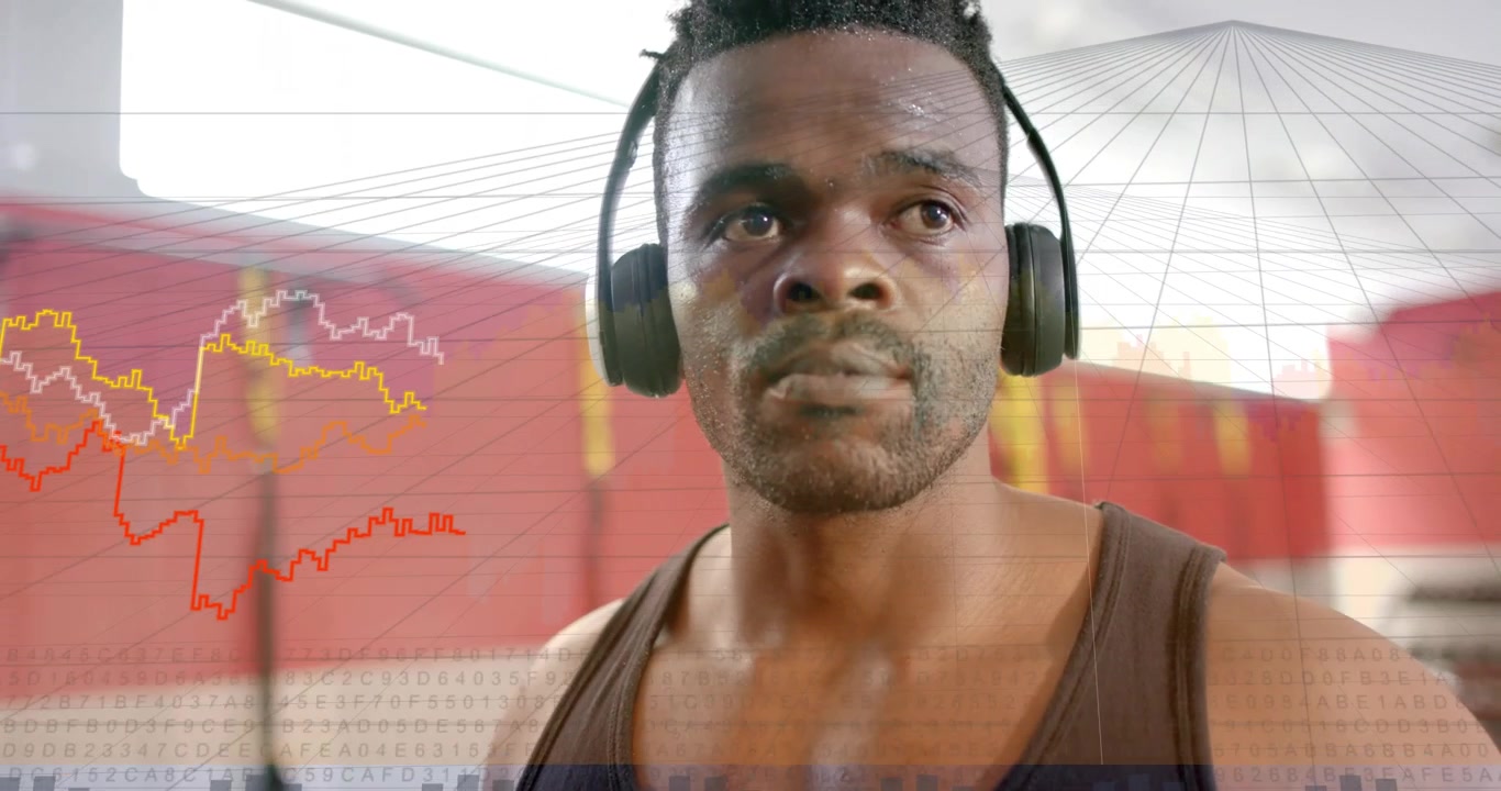Afroamerikansk mand justerer over-ear hovedtelefoner og sporer HUD-grafer i sort tanktop i fitnesscenteret
