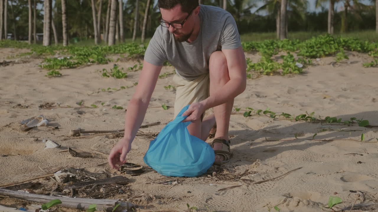 Man Cleaning Up Beach Litter