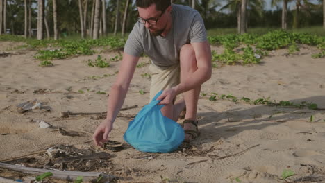 hombre limpiando la basura de la playa