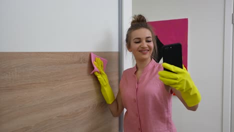 woman cleaning home and showing the process on a video call