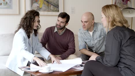 home owners looking at blueprints with interior designer