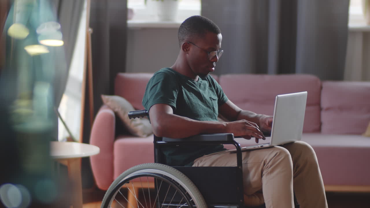 Man in Wheelchair Using Laptop