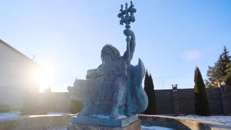 statue of a sea god in a winter garden