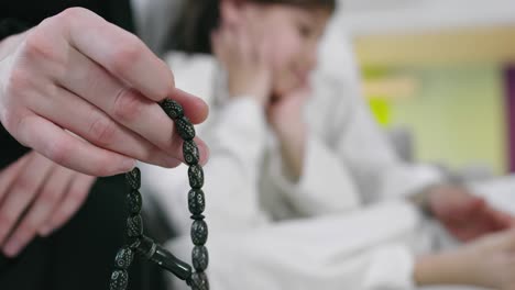 muslim women using misbaha to keep track of counting in tasbih during ramadan