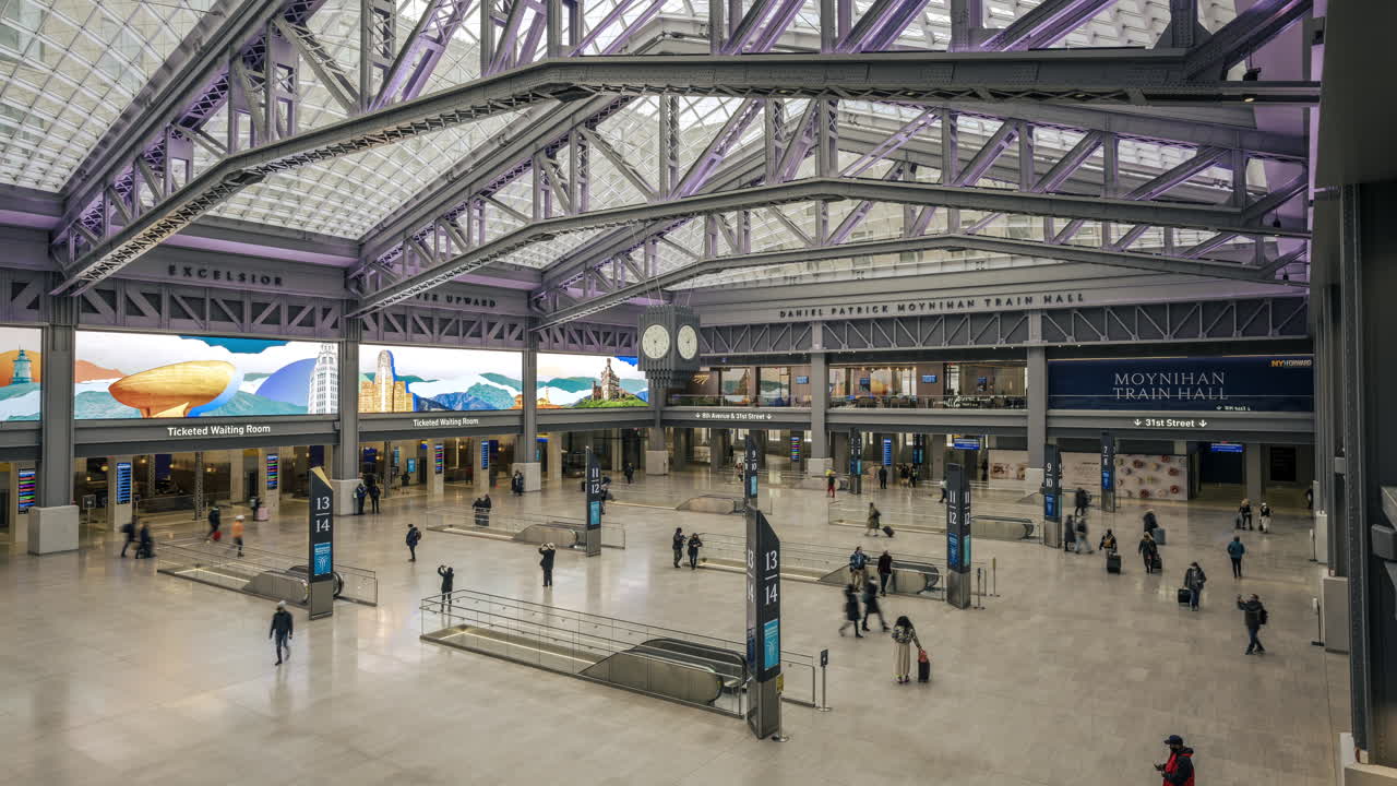 New York NY USA-January 8th, 2021 Visitors to the Daniel Patrick Moynihan Train Hall at Pennsylvania Station in New York enjoy the new space from the top level