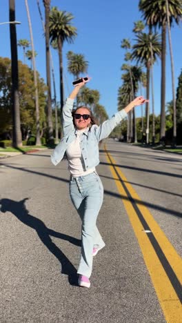 woman posing on a street with palm trees