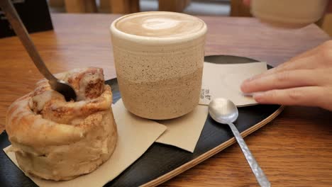 cozy coffee shop morning: latte and cinnamon roll