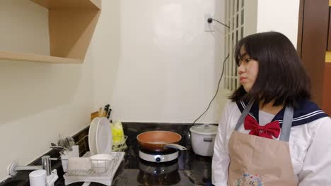 young girl pondering thoughts while cooking in modern house kitchen