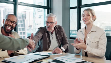 business meeting with handshake and applause in a modern office setting
