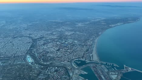 aerial view of valencia city, in se spain at sunset, from a jet cockpit