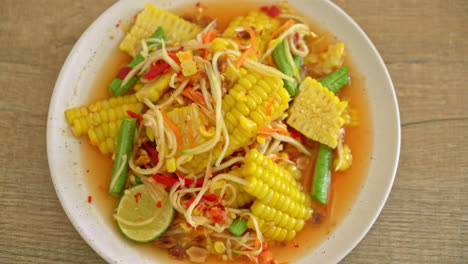 som tum - thai spicy papaya salad with corn - asian food style