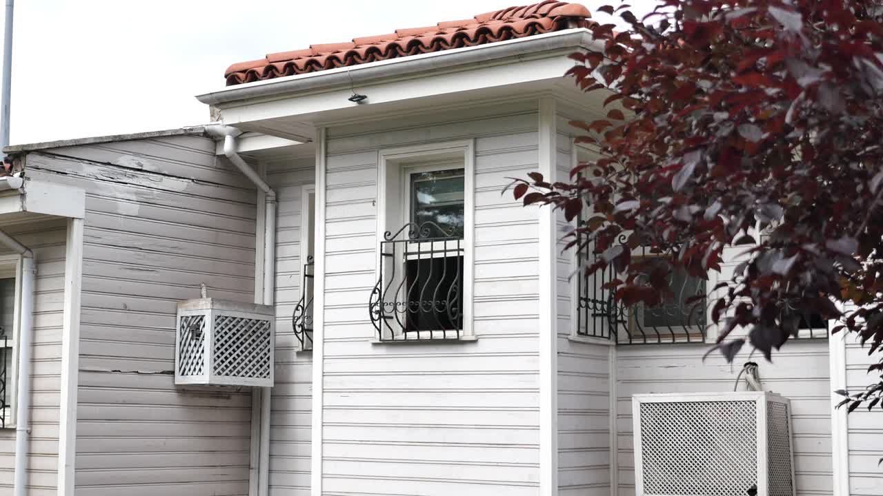 Exterior of a historic white wooden building with decorative elements