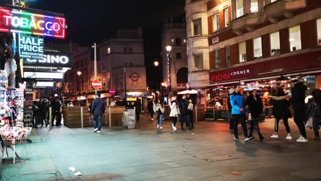 loads of tourists walking through a busy back street in the famous capital city of england named london