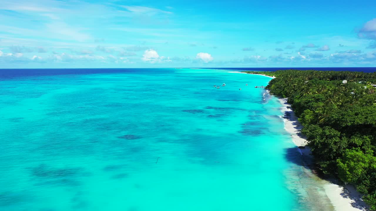 Wide turquoise lagoon with calm clear water next to white sand and rocks of exotic beach under shadow of palm trees and lush vegetation of tropical island in Caribbean