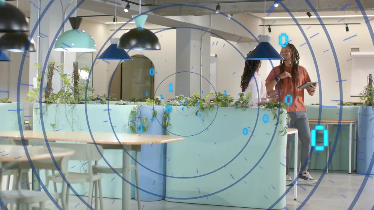 Two coworkers tapping tablet by mint planter and activating binary overlay while showing tech demo