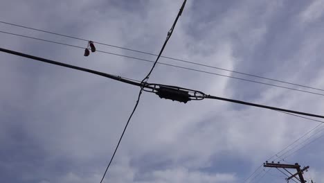 A-nice-low-angle-of-tennis-shoes-on-a-line-as-a-FedEx-plane-lands-in-Southern-California-1