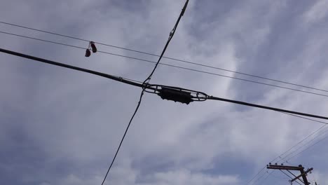 A nice low angle of tennis shoes on a line as a FedEx plane lands in Southern California 1