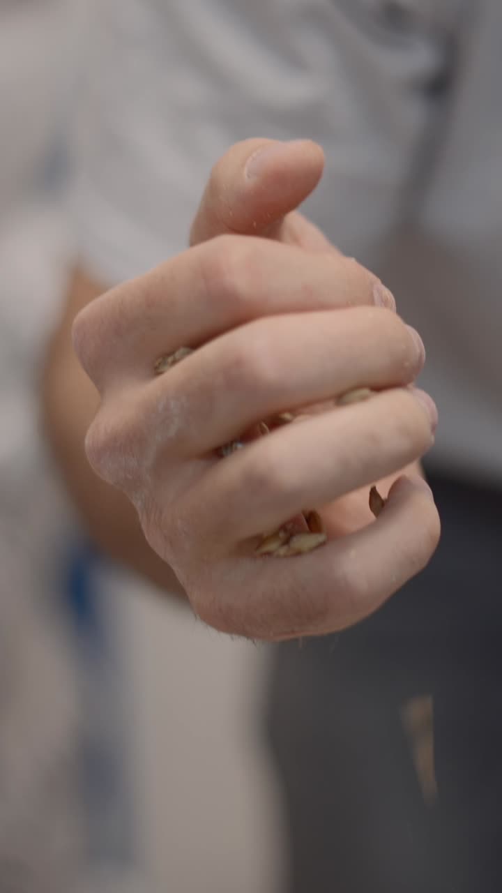Close-up of Hand Pouring Grains